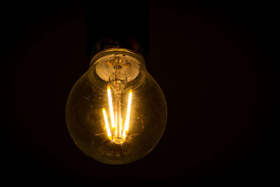 Close-up of illuminated light bulb