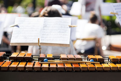 Close-up of musical equipment and sheet music in city