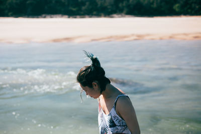 Young woman standing by river