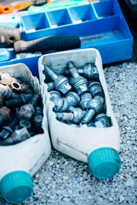 High angle view of nut bolts in bottles