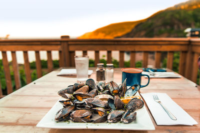 Close-up of food on table against railing