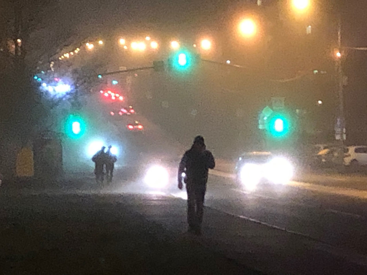 REAR VIEW OF SILHOUETTE MAN STANDING ON ILLUMINATED STREET AT NIGHT