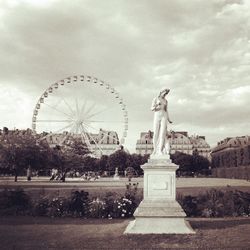 Ferris wheel against cloudy sky