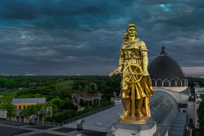 Statue of temple against cloudy sky