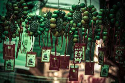 Envelopes hanging from fruits decoration in market for sale