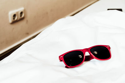 High angle view of sunglasses with reflection of illuminated light