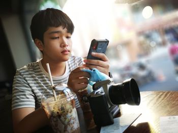 Boy photographing with mobile phone