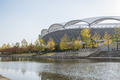 Arch bridge over river against sky