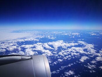 Aerial view of cloudscape over airplane wing