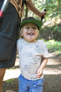 Portrait of happy young boy hiking with his dad.