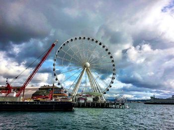 Ferris wheel against cloudy sky