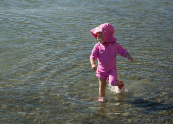 Cute girl playing at lakeshore