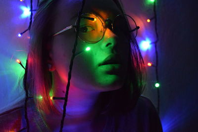 Portrait of young woman with light painting at night