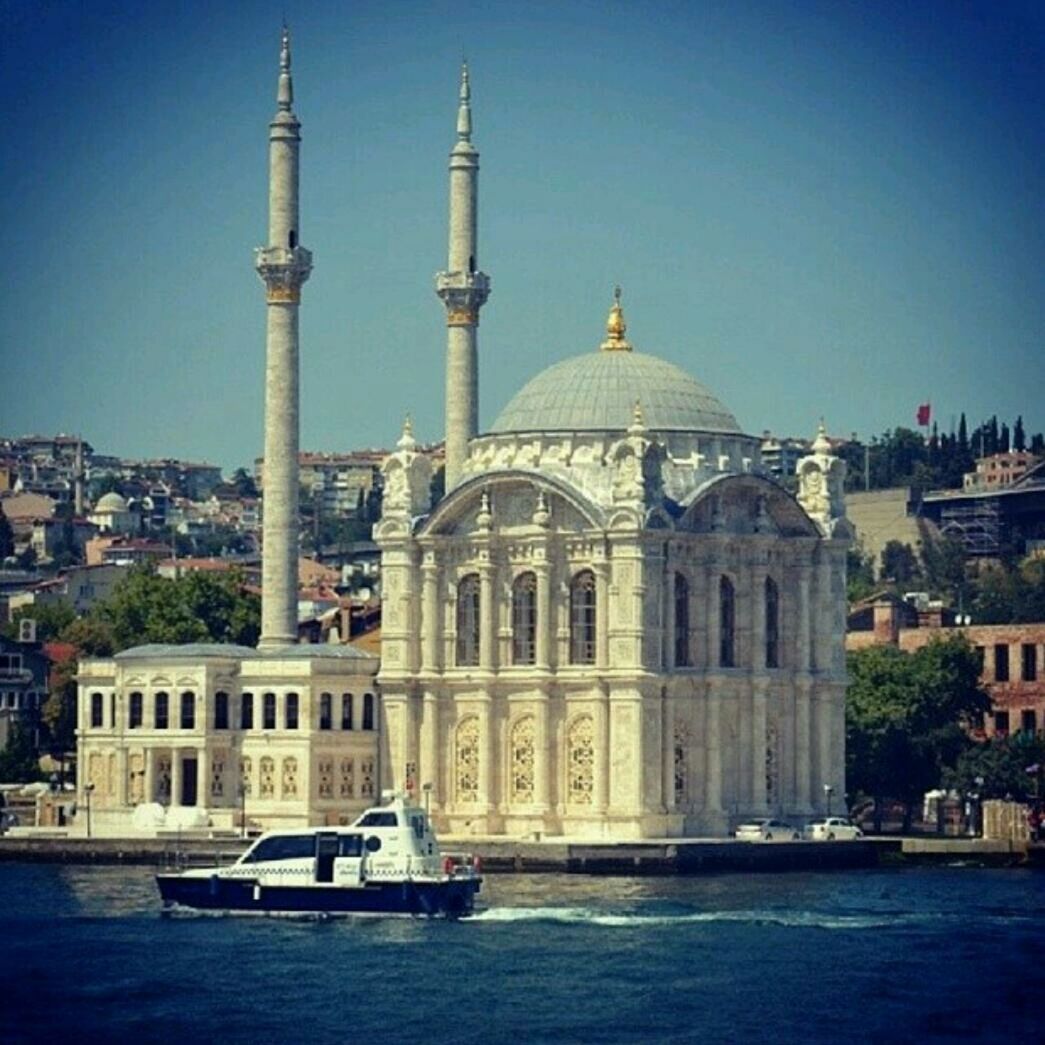 architecture, building exterior, built structure, dome, church, water, place of worship, religion, blue, spirituality, waterfront, nautical vessel, clear sky, famous place, travel, travel destinations, cathedral, transportation