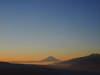 Scenic view of silhouette mountains against clear sky