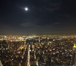 Aerial view of city lit up at night