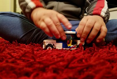 Close-up of child playing with hands