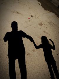 Shadow of man and woman standing on street