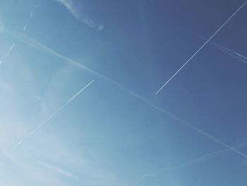 Low angle view of vapor trail in blue sky