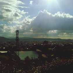 Cityscape against cloudy sky