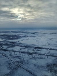 Scenic view of frozen sea against sky during winter