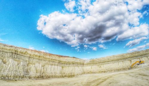 Surface level of countryside landscape against blue sky