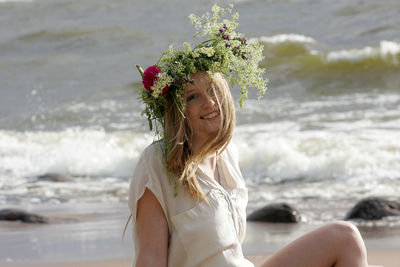 Woman wearing flowers at beach