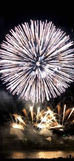 Low angle view of firework display at night