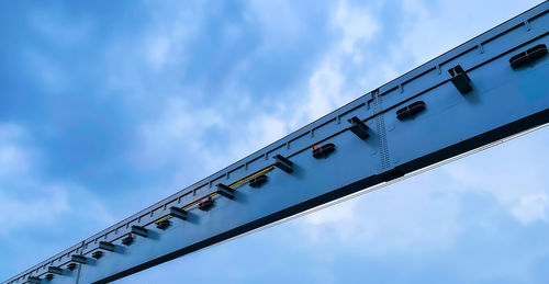 Low angle view of crane against sky