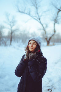 Young woman standing on snow