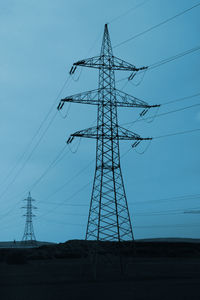 Low angle view of electricity pylon against sky