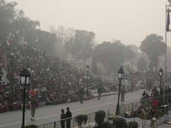 People on soccer field against trees