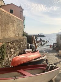 Boats moored on beach against sky