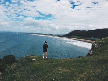 Rear view of men looking at sea