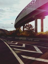 Empty road with bridge in background