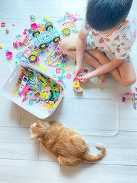 High angle view of girl drawing on floor