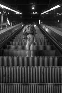 Low angle view of doll on escalator