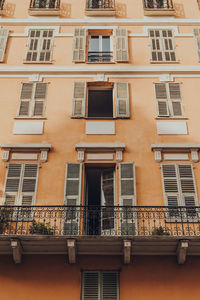 Low angle view of a traditional colourful apartment block building in nice, france.