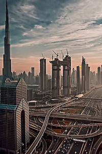 View of cityscape against cloudy sky