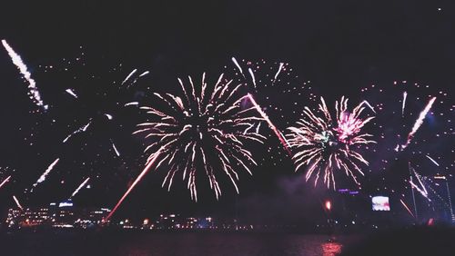 Low angle view of firework display at night