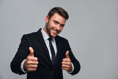 Portrait of young man against white background