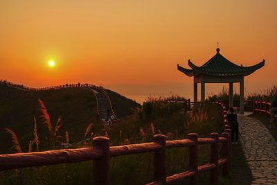 Traditional building against sky during sunset