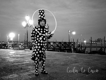 Man playing on street light at night