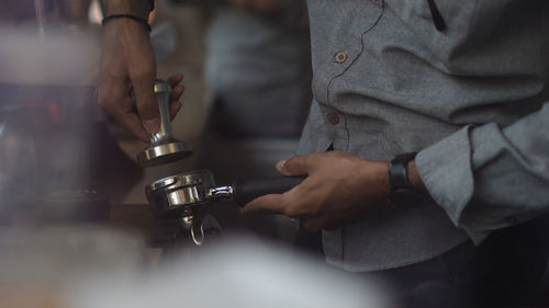 Close up of a male barista hand preparing to make a cup of coffee. selected focus.