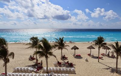 View of beach against cloudy sky