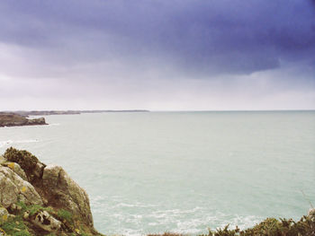 Scenic view of sea against cloudy sky