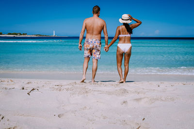 Full length of friends on beach