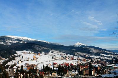 High angle view of houses in town against sky