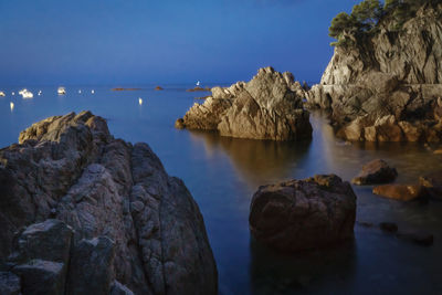 Scenic view of sea and rocks against sky