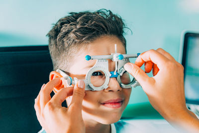 Smiling ophthalmologist doing eye test of boy